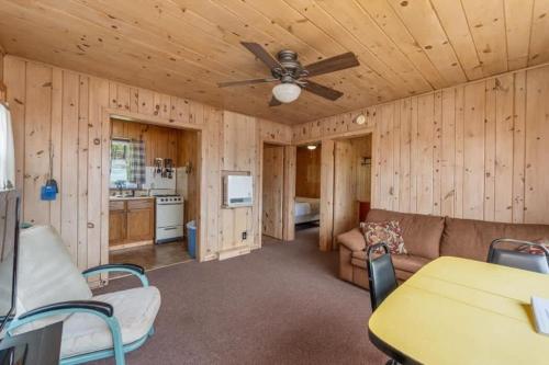 a living room with a couch and a ceiling fan at TB6 Thunder Bay Resort Cabin 6 in Phelps