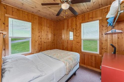 a bedroom with a bed and a ceiling fan at TB6 Thunder Bay Resort Cabin 6 in Phelps