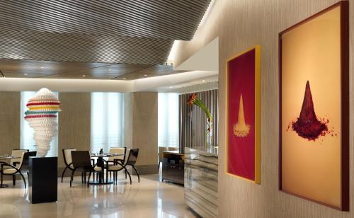 a dining room with tables and chairs in a building at Four Seasons Hotel Abu Dhabi at Al Maryah Island in Abu Dhabi