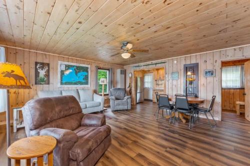 a living room with a couch and a table at TB3 Thunder Bay Resort Cabin 3 in Phelps