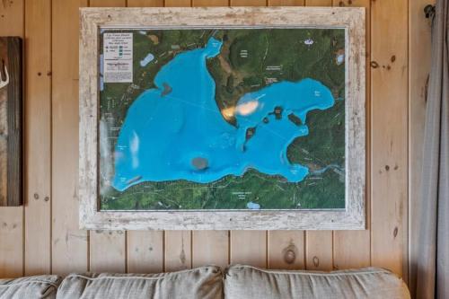 a map hanging on a wall above a couch at TB3 Thunder Bay Resort Cabin 3 in Phelps