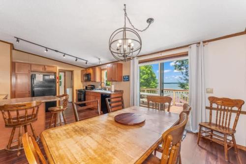 a kitchen and dining room with a table and chairs at TB-15 Thunder Bay Resort Cabin15 in Phelps