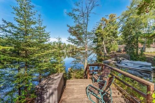 a deck with benches and a view of a lake at Clover Pines in Eagle River