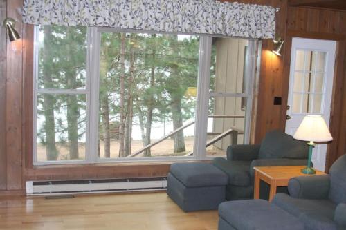 a living room with a large window at Bayview Resort Sunset Lookout Cabin 6 in Saint Germain