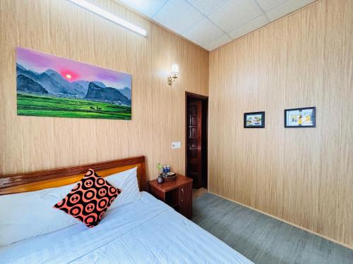 a bedroom with a bed with a pillow on it at Palm Lodge in Bố Trạch