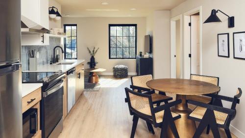 a kitchen with a wooden table and chairs at The Dylin in Madison