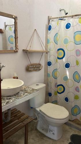 a bathroom with a sink and a toilet and a shower at Mi refugio in Moñitos