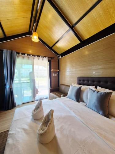 a large bed with two pillows on top of it at Walden Moon Resort in Ko Lanta Yai