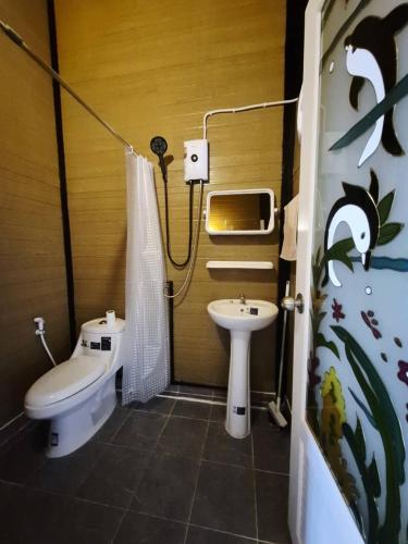 a small bathroom with a toilet and a sink at Walden Moon Resort in Ko Lanta Yai