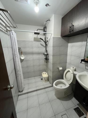a bathroom with a toilet and a sink at Cozy Loft Studio with Balcony in Cebu City in Cebu City