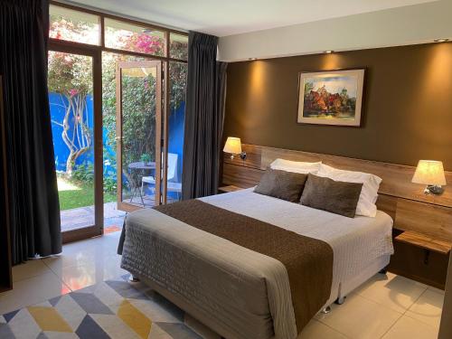 a bedroom with a large bed and a large window at Villa San José in Arequipa