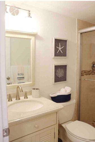 a white bathroom with a sink and a toilet at Your Happy Place ON THE BEACH! in Key Colony Beach