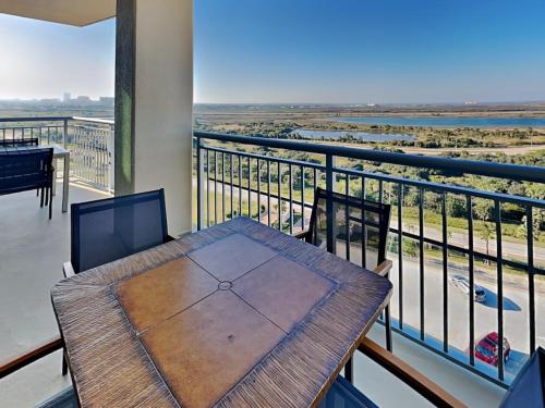 a balcony with a table and a view of the ocean at Palisade Palms TW1012 - Sea Escape in Galveston