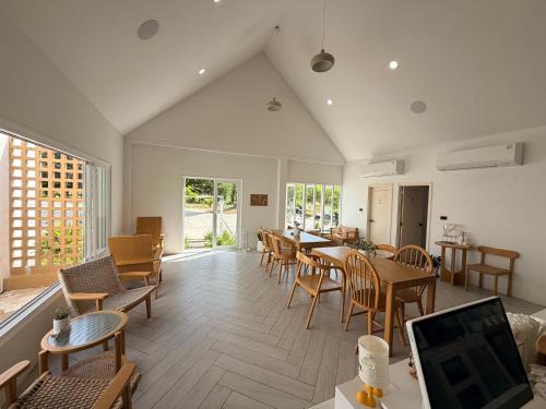 a living room with a dining room table and chairs at L'camp and cafe' Kohchang in Trat