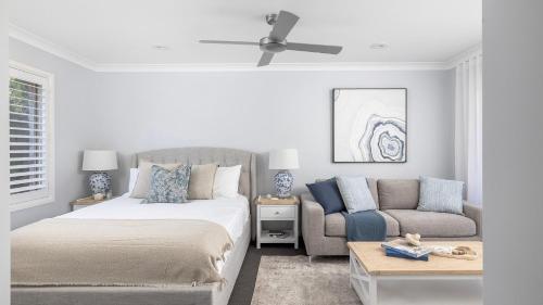 a bedroom with a bed and a couch at Serenity in Corlette
