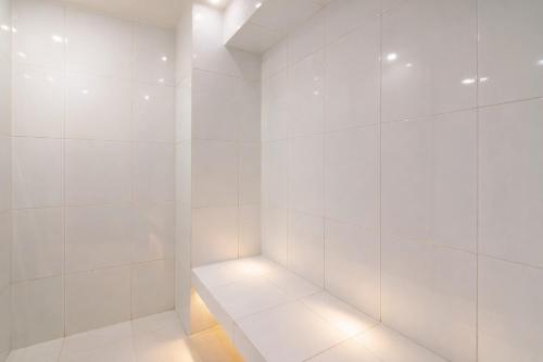 a white walk in shower with a light in it at TOP VIEW PENTHOUSE Private Rooftop, Wi-Fi 500Mbps, Air Conditioning, Grill, Pool and Gym in Mexico City