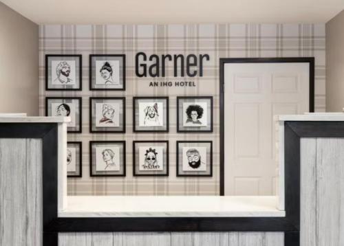 a room with framed pictures on a wall at Garner Hotel Albuquerque Airport by IHG in Albuquerque