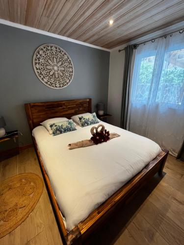 a bedroom with a bed with a teddy bear on it at Les panoramiks des Makes in Saint-Louis