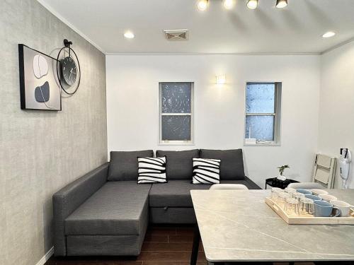 a living room with a couch and a table at Higashirokugō, Ota City -3LDK house-OT0493 in Tokyo