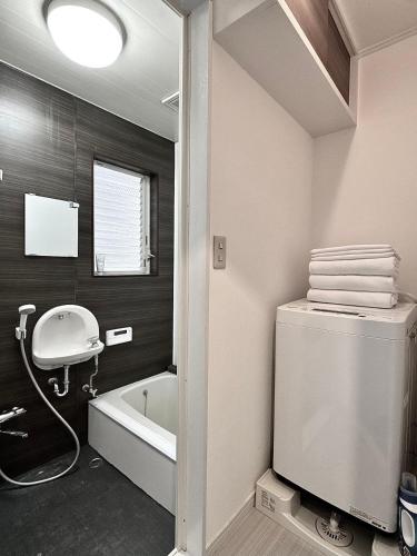 a bathroom with a toilet and a sink and a bath tub at Higashirokugō, Ota City -3LDK house-OT0493 in Tokyo