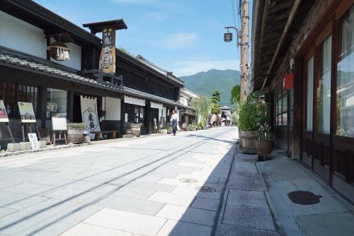an empty street in an old town with buildings at Bouzantei Kotobuki in Ueda