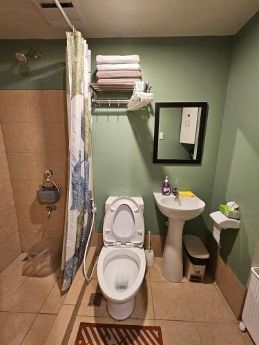 a bathroom with a toilet and a sink at Your Cozy Space in Stanford Suites 3 Brgy Inchican Silang Cavite in Silang