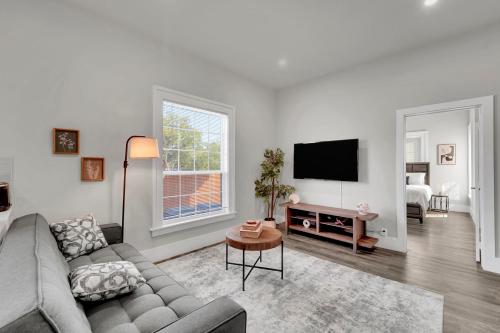a living room with a couch and a flat screen tv at Downtown Dallas 1BD Haven in Dallas