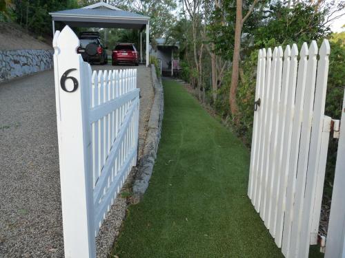 a white picket fence with a shed on it at Bushland Breeze - Self Contained Unit in Gladstone