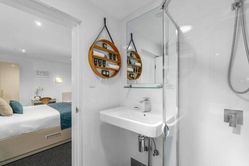 a bathroom with a sink and a shower at North Adelaide Boutique Stays Accommodation in Adelaide