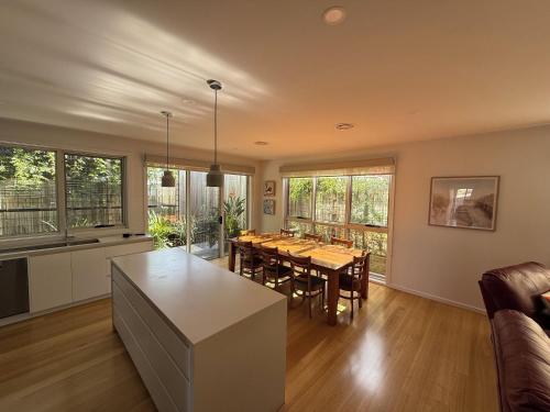 a kitchen and dining room with a table and chairs at Cowes Central Beach Villa II in Cowes