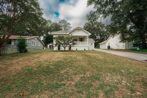a house with a large yard in front of it at Spacious 4BR Home Pool and Comfort in Columbus