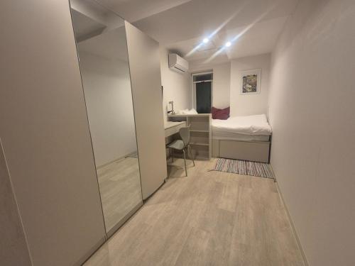 a small room with a bed and a desk at Seoul On Stay in Seoul
