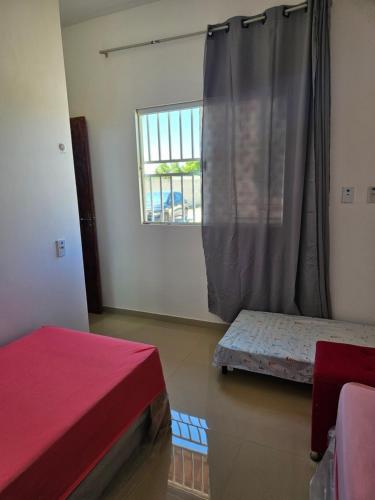 a room with two beds and a window at Cantinho das Joaninhas in Prado