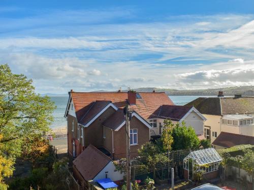 a group of houses in front of the ocean at Sea View Cottage in Rhos-on-Sea