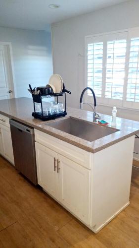 a kitchen with a sink and a counter top at Normandie Vibes Hostel in Los Angeles