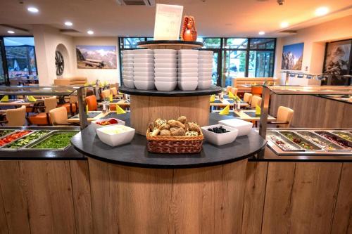 a buffet line with food on a table in a restaurant at Hotel Victoriya in Kaprun