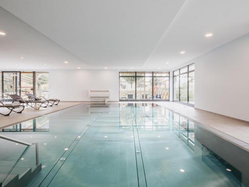 an empty swimming pool with glass floors and windows at Hotel Victoriya in Kaprun