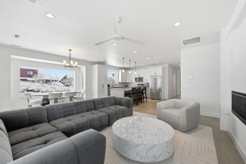 a living room with a couch and a dining room at Trappers Ridge Powder Haven in Eden
