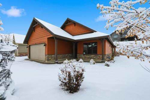 a house with a snow covered yard in front of it at Trappers Ridge Powder Haven in Eden