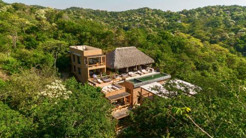 an aerial view of a house in the middle of a forest at Casa Yute Boutique Hotel Playa Aragon in San Agustinillo
