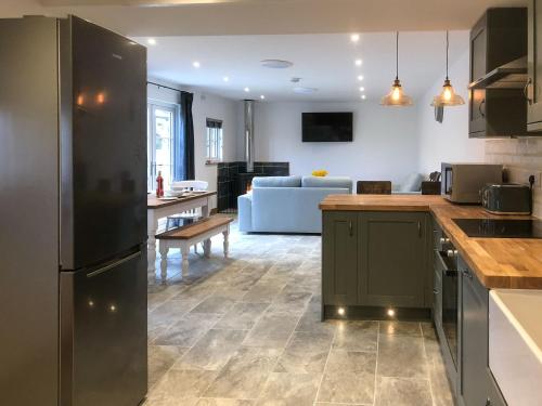 a kitchen and living room with a couch at Middle Hanter - Uk37355 in Old Radnor