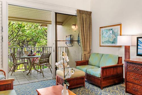 a living room with a couch and a balcony at Napili Shores E239 in Lahaina