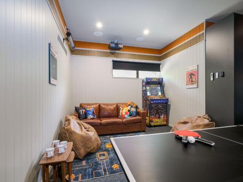 a living room with a couch and a table at Seventeen On Cheltenham in Hanmer Springs
