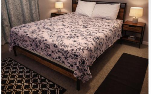 a bedroom with a bed with a purple and white blanket at McDaniel House Private Room 7 Shared Bathroom in Atlanta