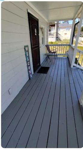 a wooden porch with a bench on a house at McDaniel House Private Room 7 Shared Bathroom in Atlanta