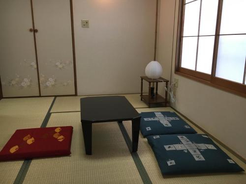 a room with a table and a stool in a room at Jemsty Inn Hakone Ashinoko in Hakone