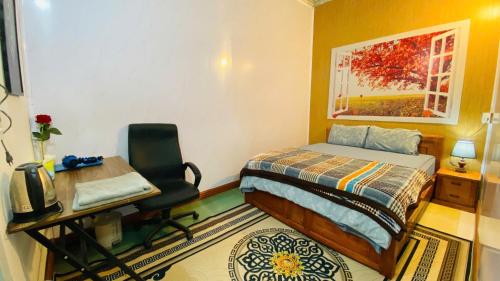 a bedroom with a bed and a desk and a chair at Nam My Van Homestay - Thai Nguyen in Thái Nguyên