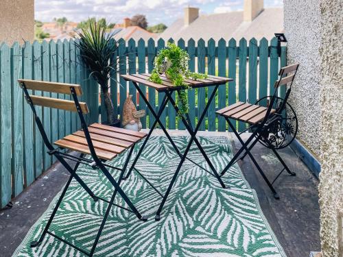a table and chairs with plants on a fence at The Bolt Hole in Wooler
