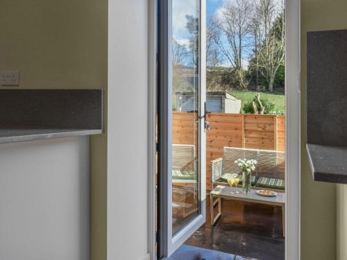 a view of a patio through a sliding glass door at Brun Cottage in Worsthorne