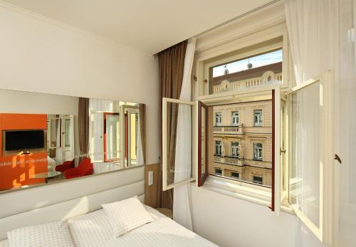 Postel nebo postele na pokoji v ubytování Salvator Boutique Hotel vegan-friendly